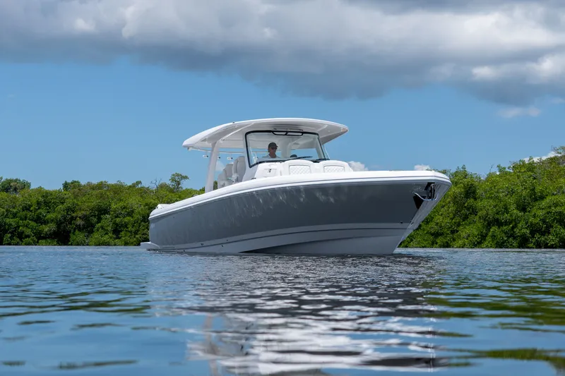 Slide: The Image of Intrepid 43 Nomad SE 2026 on calm water with green backdrop. - 22