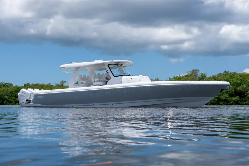 Slide: The Image of 2026 Intrepid 43 Nomad SE on calm water under cloudy sky. - 23