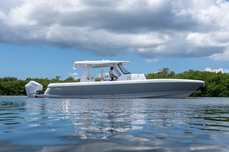 Slide: The Image of 2026 Intrepid 43 Nomad SE on calm water under cloudy sky. - 24
