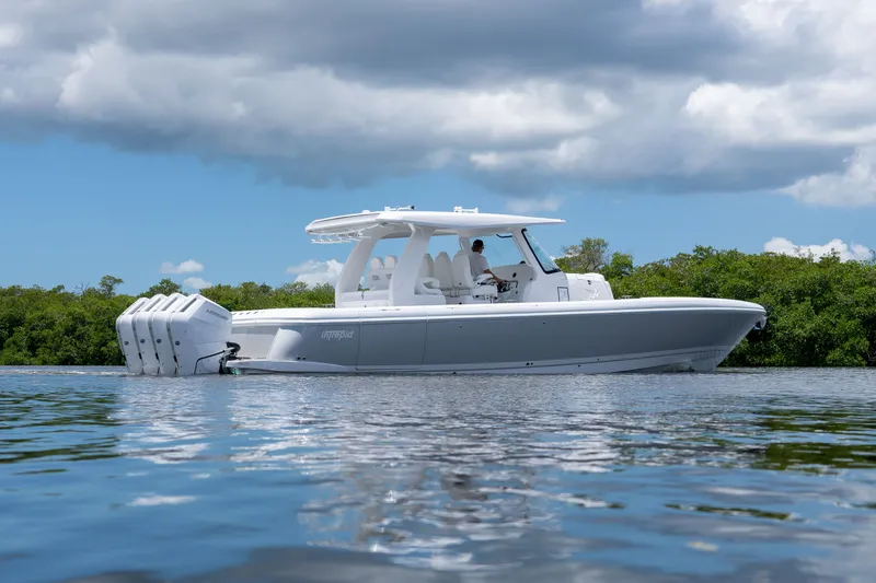 Slide: The Image of Intrepid 43 Nomad SE 2026 on calm water under cloudy sky. - 25
