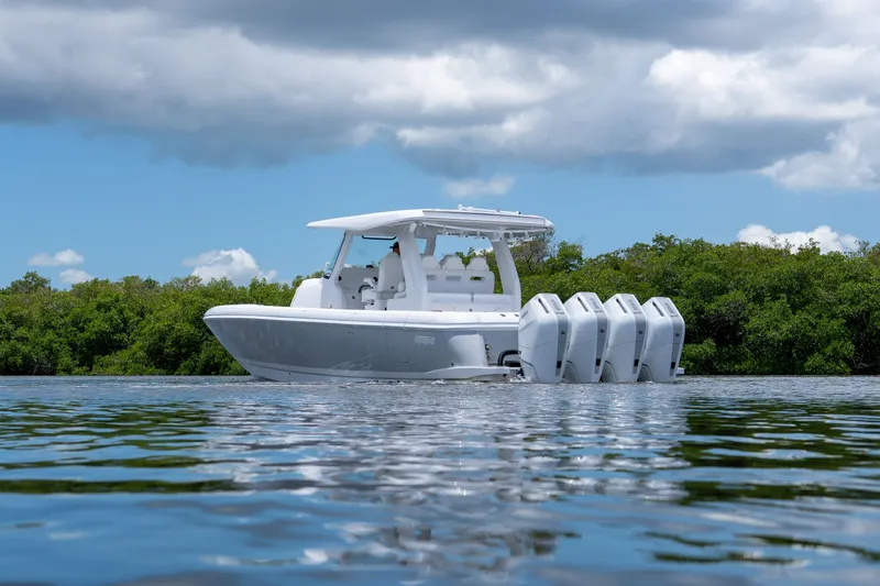 Slide: The Image of Intrepid 43 Nomad SE 2026 on calm water with lush greenery backdrop. - 26
