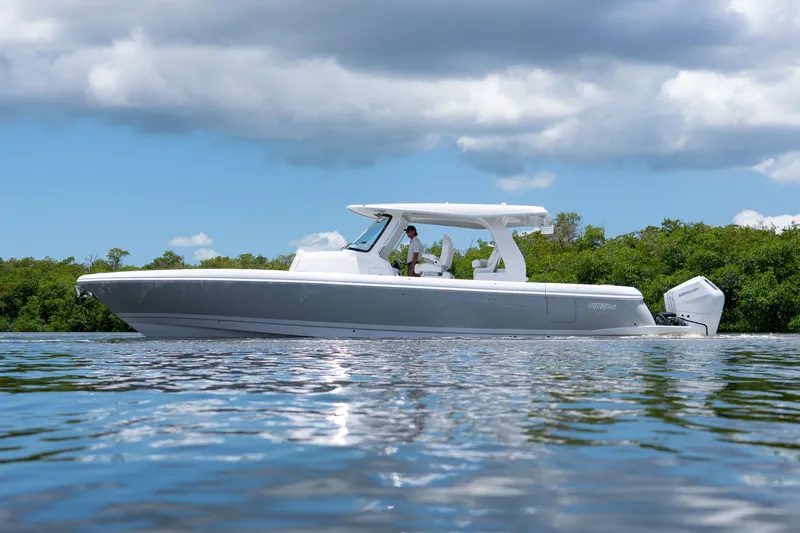 Slide: The Image of 2026 Intrepid 43 Nomad SE on calm water with green backdrop. - 27