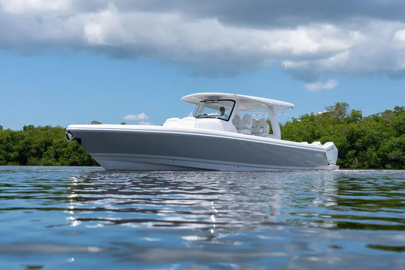 Slide: The Image of Intrepid 43 Nomad SE 2026 on calm water with green backdrop. - 29