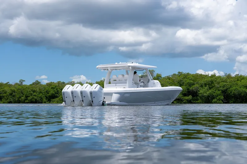 Slide: The Image of Intrepid 43 Nomad SE 2026 on calm water with lush greenery backdrop. - 3