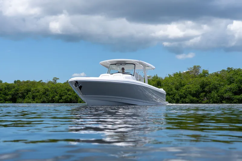 Slide: The Image of Intrepid 43 Nomad SE 2026 on calm water with green backdrop. - 30