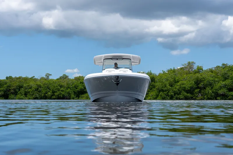 Slide: The Image of Intrepid 43 Nomad SE 2026 on calm water with green backdrop. - 31