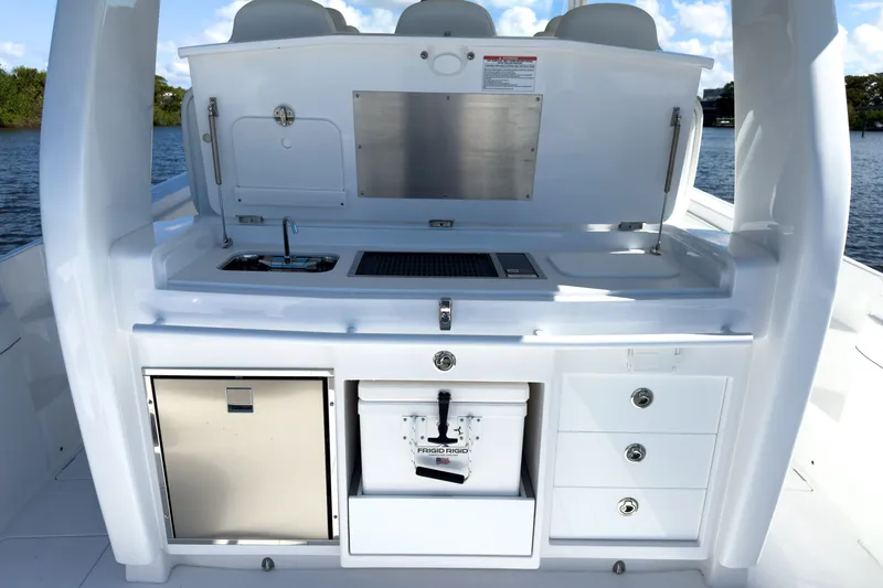 Slide: The Image of Intrepid 43 Nomad SE 2026 boat kitchen with sink and storage. - 6