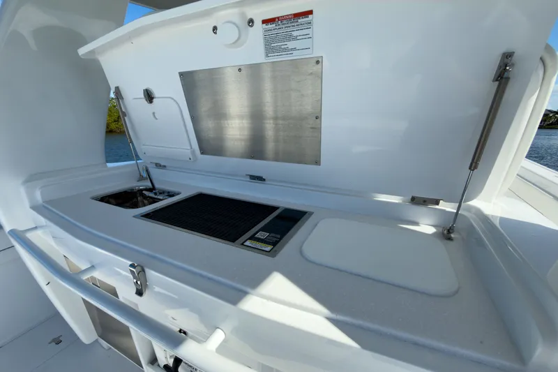 Slide: The Image of Intrepid 43 Nomad SE 2026 boat kitchen with grill and sink. - 7
