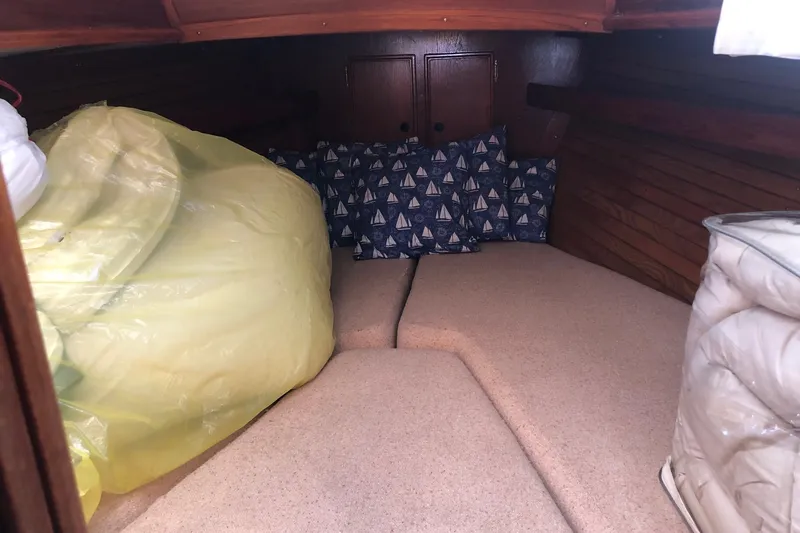 Slide: The Image of 1979 Cape Dory 36 interior cabin with cushions and storage space. - 11