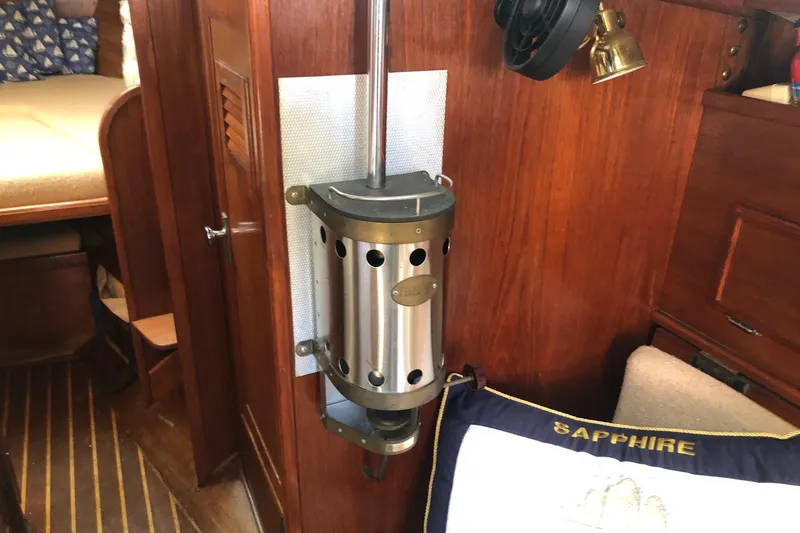 Slide: The Image of Interior of a 1979 Cape Dory 36 sailboat with wood paneling and nautical decor. - 13