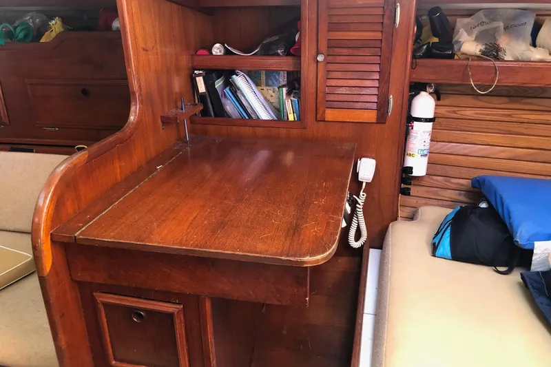 Slide: The Image of 1979 Cape Dory 36 interior with wooden desk, shelves, and fire extinguisher. - 15