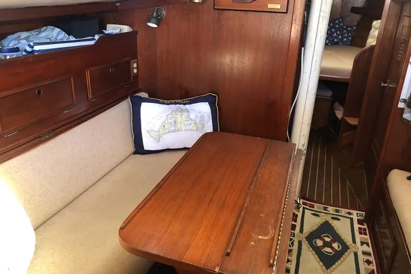 Slide: The Image of Interior of 1979 Cape Dory 36 sailboat with wooden table and cozy seating area. - 16