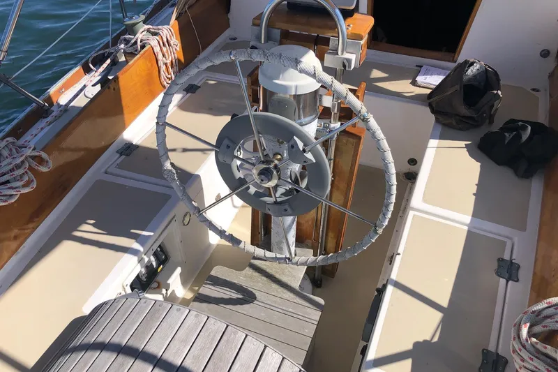 Slide: The Image of Cockpit of 1979 Cape Dory 36 sailboat with wooden accents and steering wheel. - 2