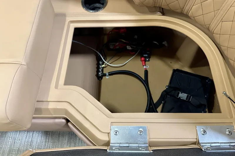 Slide: The Image of Open storage compartment in 2026 Godfrey Sweetwater 22' Split Bench Tritoon boat. - 11