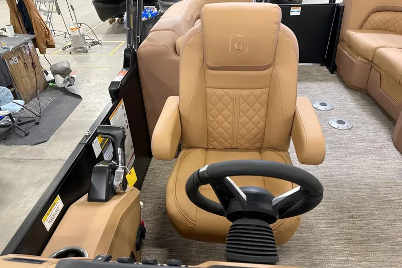 Slide: The Image of Luxurious tan captain's chair in 2026 Godfrey Sweetwater 22' Split Bench Tritoon boat. - 7