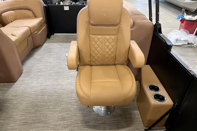 Slide: The Image of Luxurious tan seating on 2026 Godfrey Sweetwater 22' Split Bench Tritoon boat interior. - 8