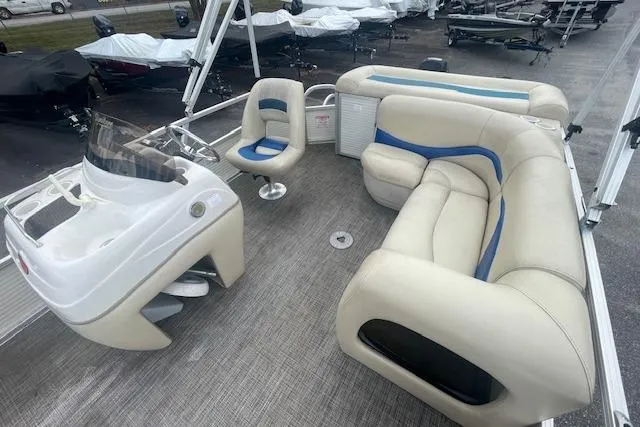 Slide: The Image of 2009 Sun Tracker Party Barge 21 interior with seating and helm, showcasing spacious design. - 3