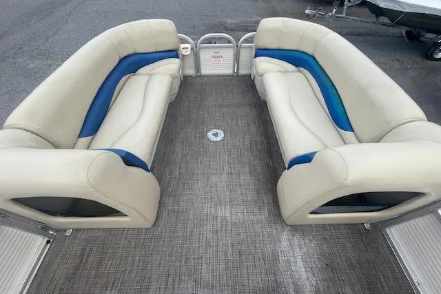 Slide: The Image of 2009 Sun Tracker Party Barge 21 interior with beige and blue seating. - 6