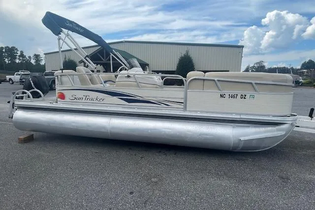 Slide: The Image of 2009 Sun Tracker Party Barge 21 pontoon boat parked on asphalt. - 7