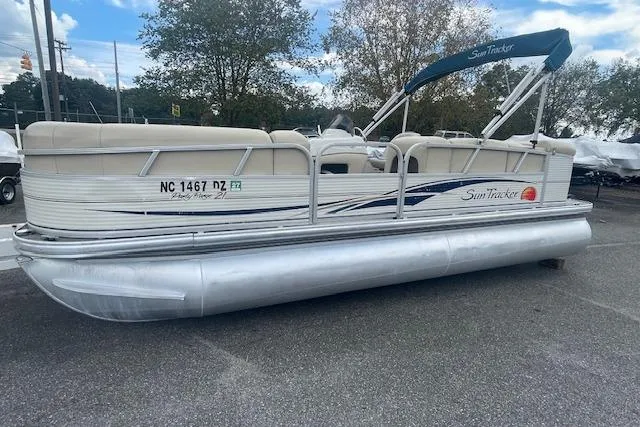 Slide: The Image of 2009 Sun Tracker Party Barge 21 pontoon boat parked on pavement. - 8