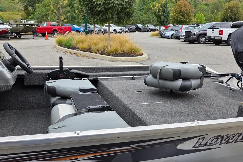 Slide: The Image of 2014 Lowe Stryker 17 boat interior in parking lot, featuring gray seating and steering wheel. - 3