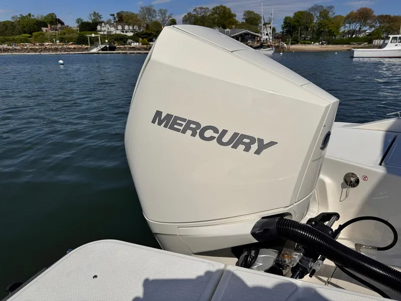 Slide: The Image of Boston Whaler 220 Dauntless 2022 with Mercury outboard engine on calm water. - 11