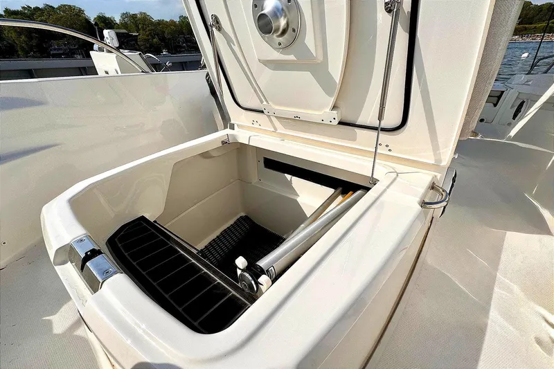 Slide: The Image of Open storage compartment on 2022 Boston Whaler 220 Dauntless boat. - 6
