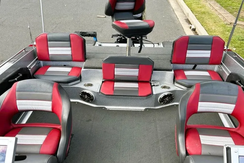 Slide: The Image of 2016 Ranger 190LS boat interior with red and gray seating, cup holders, and speakers. - 3