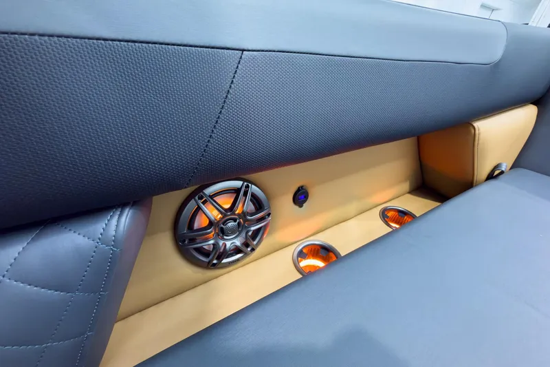 Slide: The Image of Luxurious interior of 2026 Godfrey Sweetwater 22' Tritoon with illuminated speakers and seating. - 13