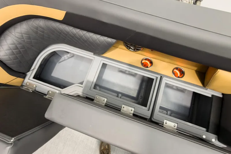 Slide: The Image of Interior of 2026 Godfrey Sweetwater 22' Tritoon with storage compartments and stylish seating. - 16