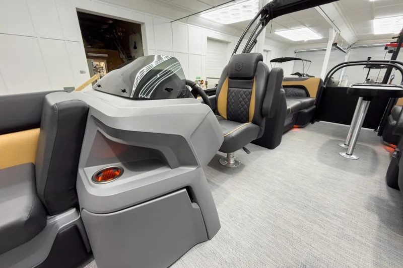 Slide: The Image of Luxurious interior of 2026 Godfrey Sweetwater 22' Split Bench Tritoon, featuring modern seating and helm. - 18