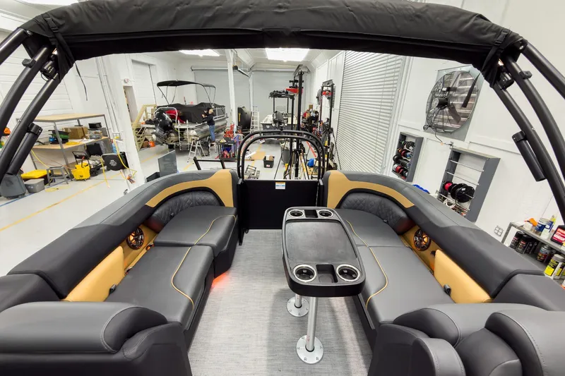 Slide: The Image of Luxurious interior of 2026 Godfrey Sweetwater 22' Split Bench Tritoon, featuring plush seating and table. - 25