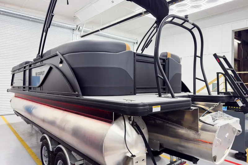 Slide: The Image of 2026 Godfrey Sweetwater 22' Split Bench Tritoon in a showroom, showcasing sleek design and modern features. - 7