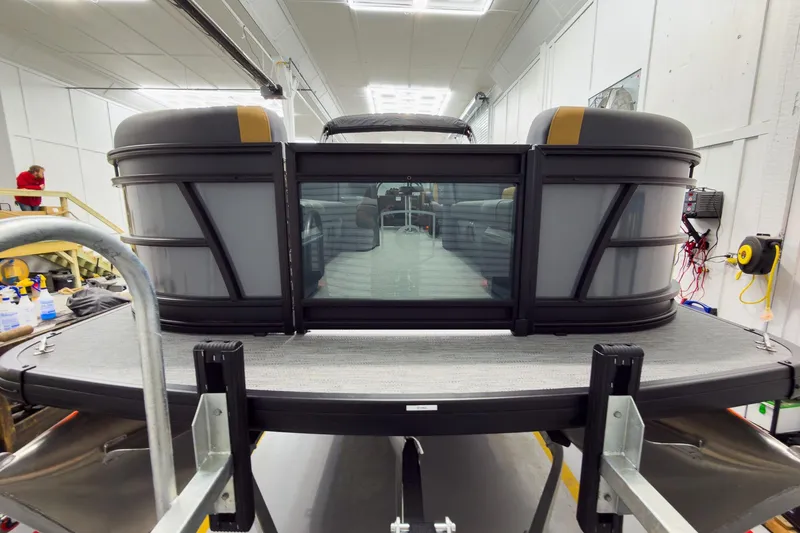 Slide: The Image of 2026 Godfrey Sweetwater 22' Split Bench Tritoon in a workshop, rear view. - 8