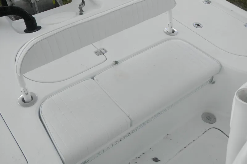 Slide: The Image of 2013 Yellowfin 24 Bay boat interior with white seating and deck details. - 11