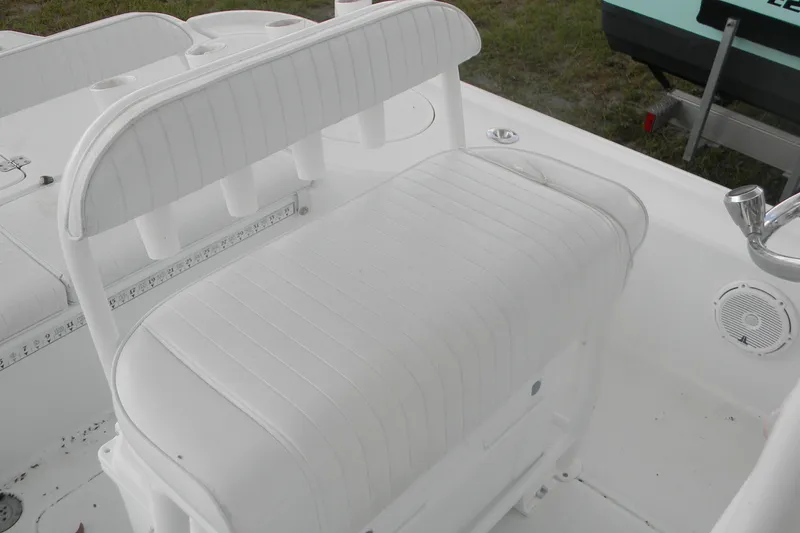 Slide: The Image of 2013 Yellowfin 24 Bay boat interior with white seating and rod holders. - 12