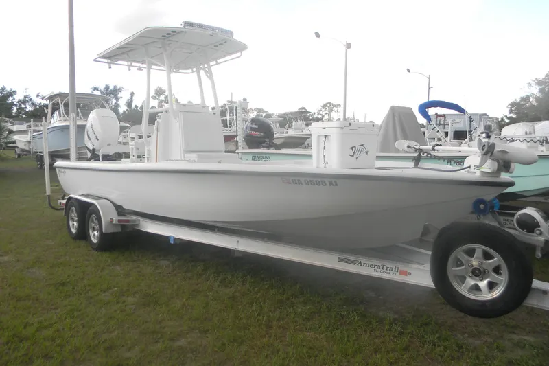 Slide: The Image of 2013 Yellowfin 24 Bay boat on trailer, parked on grass, side view. - 5
