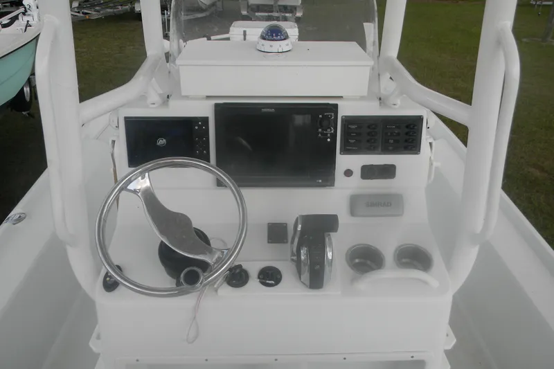 Slide: The Image of 2013 Yellowfin 24 Bay boat console with steering wheel and navigation equipment. - 8