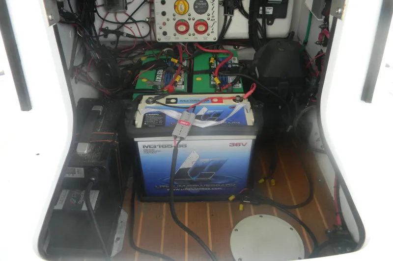Slide: The Image of 2013 Yellowfin 24 Bay boat battery compartment with wiring and power systems. - 9