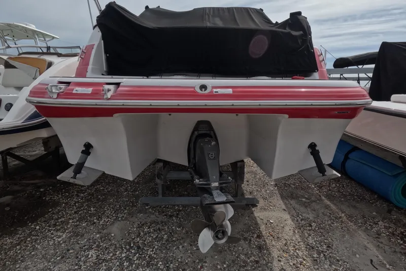 Slide: The Image of 2012 Four Winns V265 boat, rear view with covered deck and visible propeller. - 10