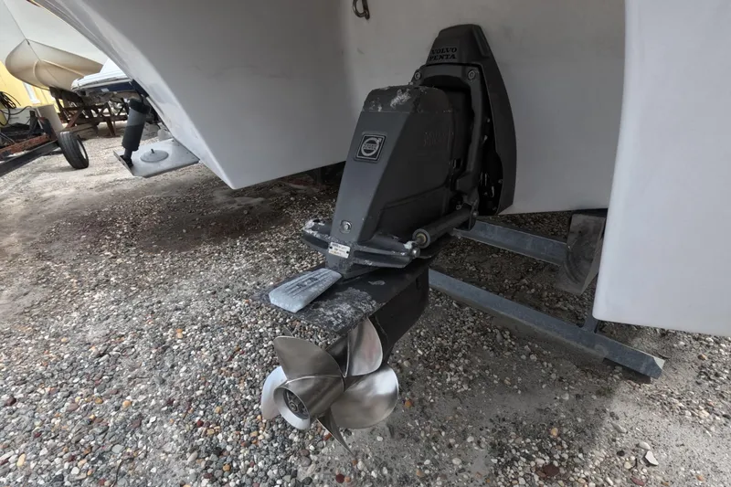 Slide: The Image of 2012 Four Winns V265 boat with Volvo Penta outdrive on gravel surface. - 16