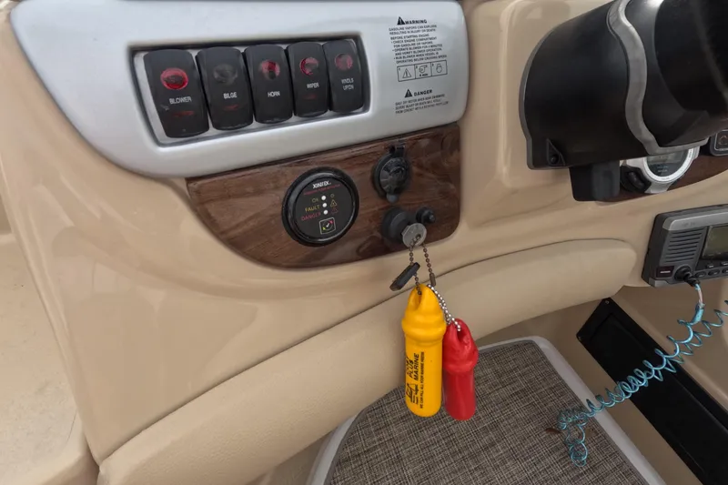 Slide: The Image of Control panel of 2012 Four Winns V265 boat with switches and safety lanyards. - 38