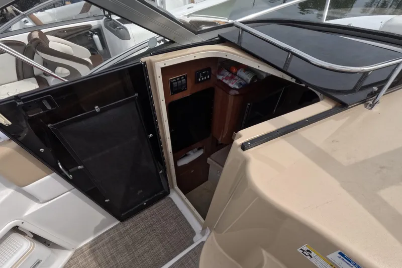 Slide: The Image of 2012 Four Winns V265 boat interior with cabin entrance and seating area. - 39