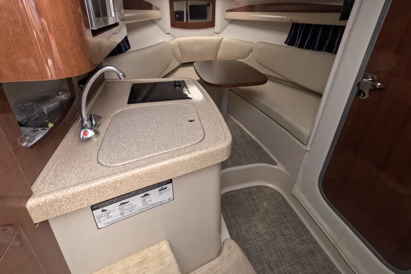 Slide: The Image of Interior of 2012 Four Winns V265 boat with kitchenette and seating area. - 43