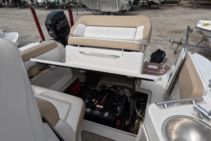 Slide: The Image of 2012 Four Winns V265 boat interior with open engine compartment and seating area. - 68