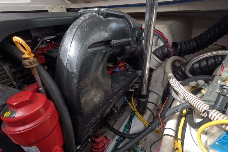 Slide: The Image of Engine compartment of a 2012 Four Winns V265 boat, showcasing various mechanical components. - 72