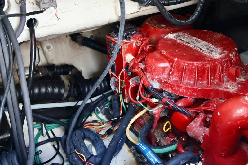 Slide: The Image of Engine compartment of a 2006 Pursuit 3070 Offshore boat with red components and wiring. - 12