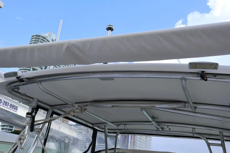 Slide: The Image of 2006 Pursuit 3070 Offshore boat canopy with cityscape background. - 16