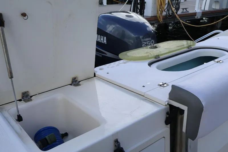 Slide: The Image of 2006 Pursuit 3070 Offshore boat with Yamaha 250 engine, featuring storage compartments. - 17
