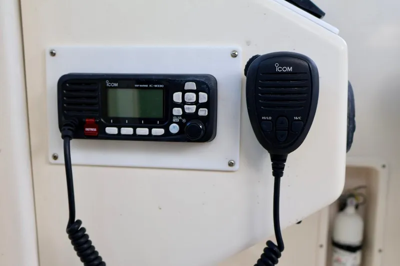 Slide: The Image of VHF marine radio on 2006 Pursuit 3070 Offshore boat dashboard. - 21